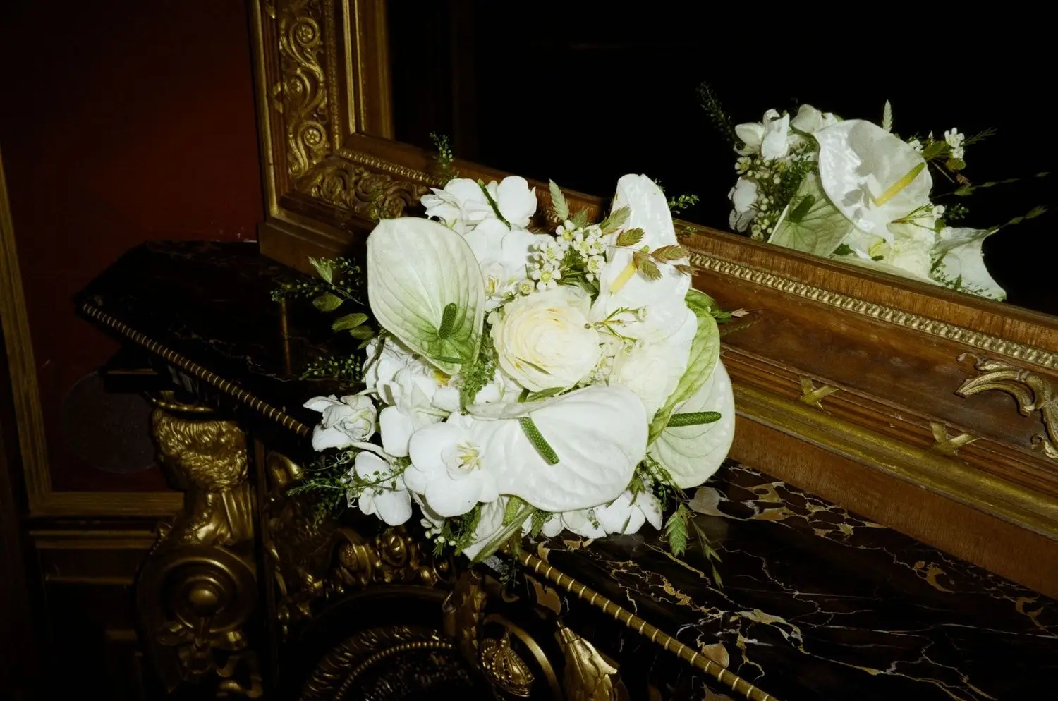 White bridal bouquet on a gilded piano, on 35mm film